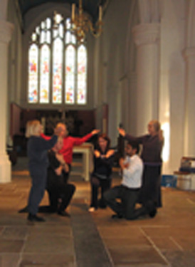 Dancers in semi-circle, three dancers kneeling